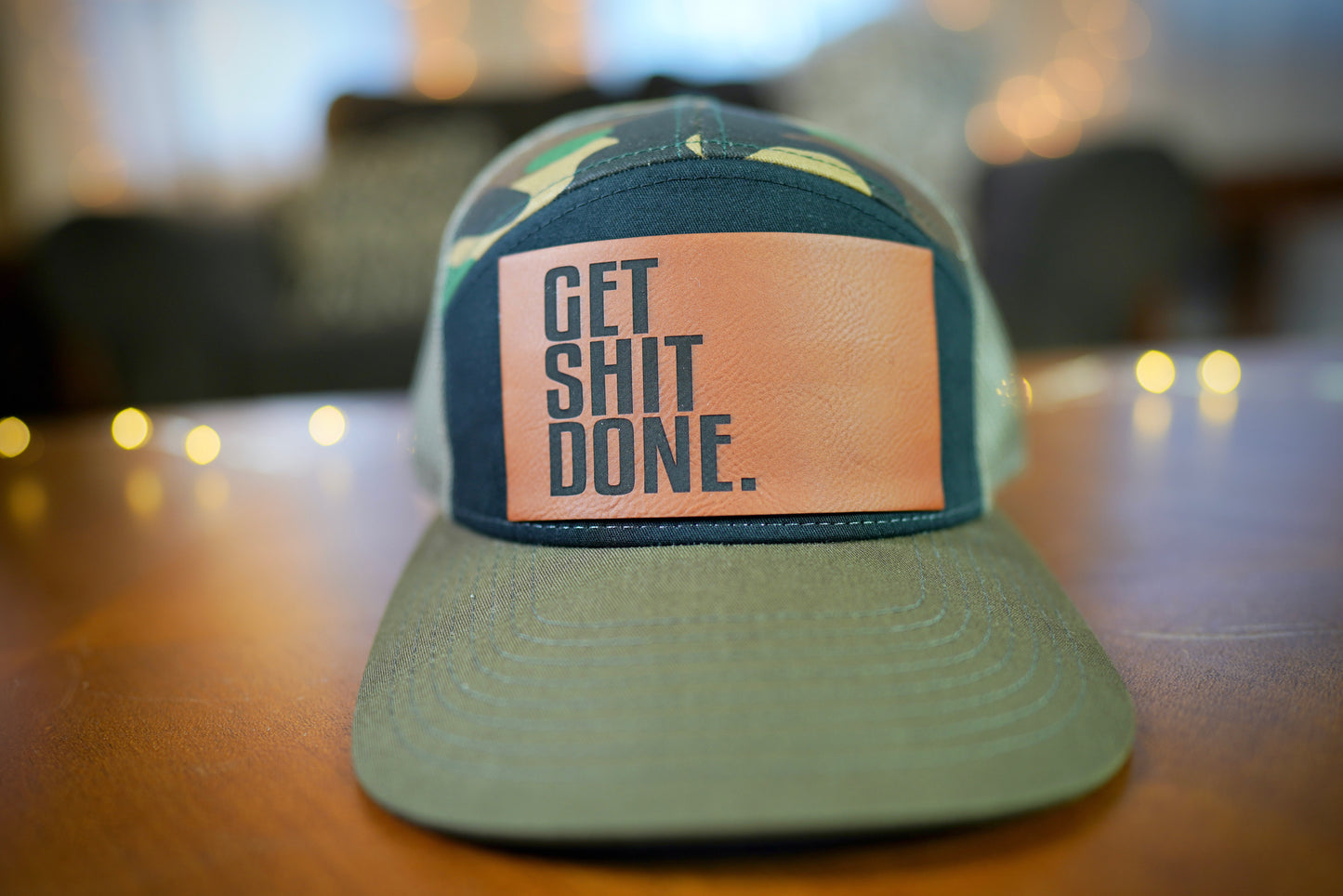 "GET SHIT DONE" 7 Panel Trucker Hat (Black/ Green Camo/ Loden)