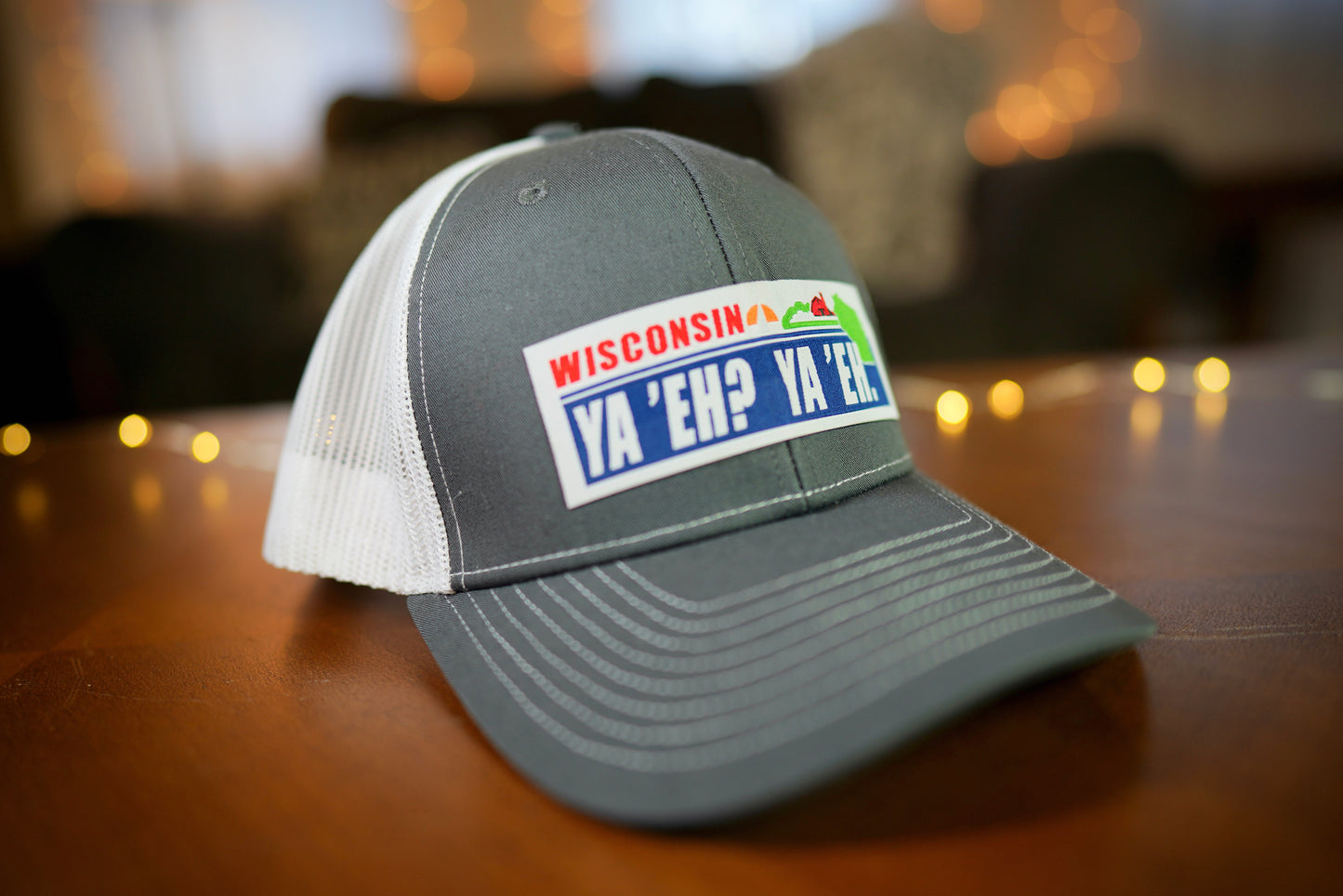 "Ya 'Eh? Ya 'Eh." Wisconsin Plate Design Trucker Hat (White Mesh/ Charcoal Fabric)
