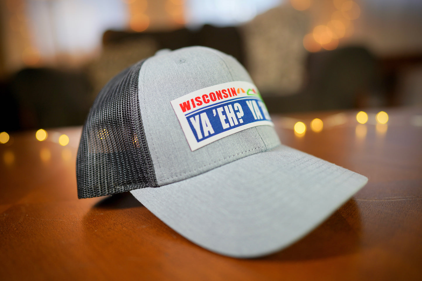 "Ya 'Eh? Ya 'Eh." Wisconsin Plate Design Trucker Hat (Black Mesh/ Heather Grey Fabric)