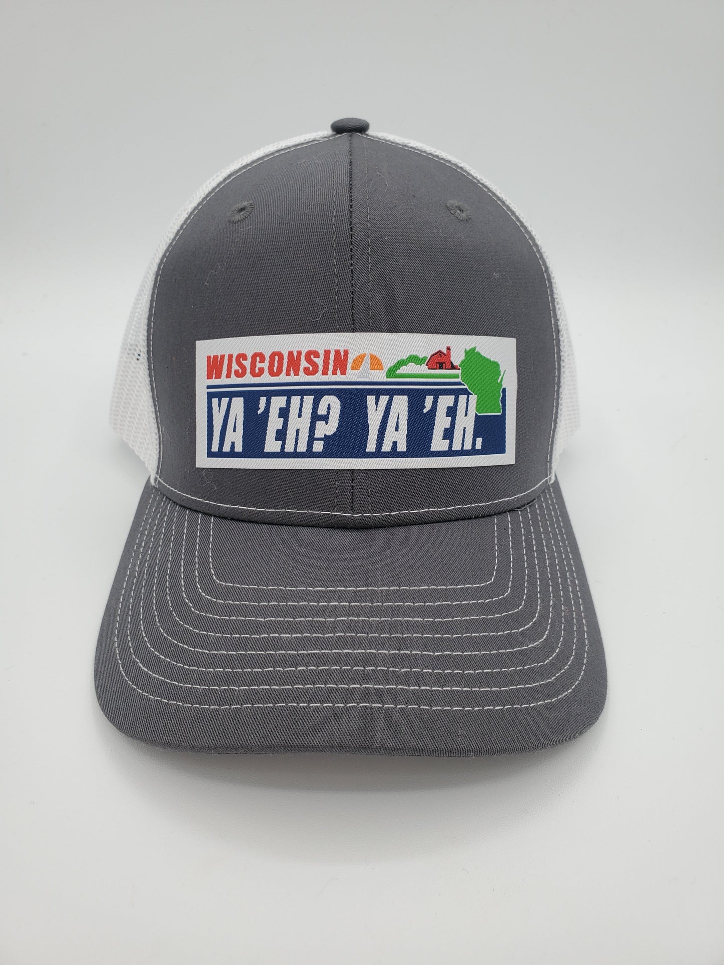 "Ya 'Eh? Ya 'Eh." Wisconsin Plate Design Trucker Hat (White Mesh/ Charcoal Fabric)