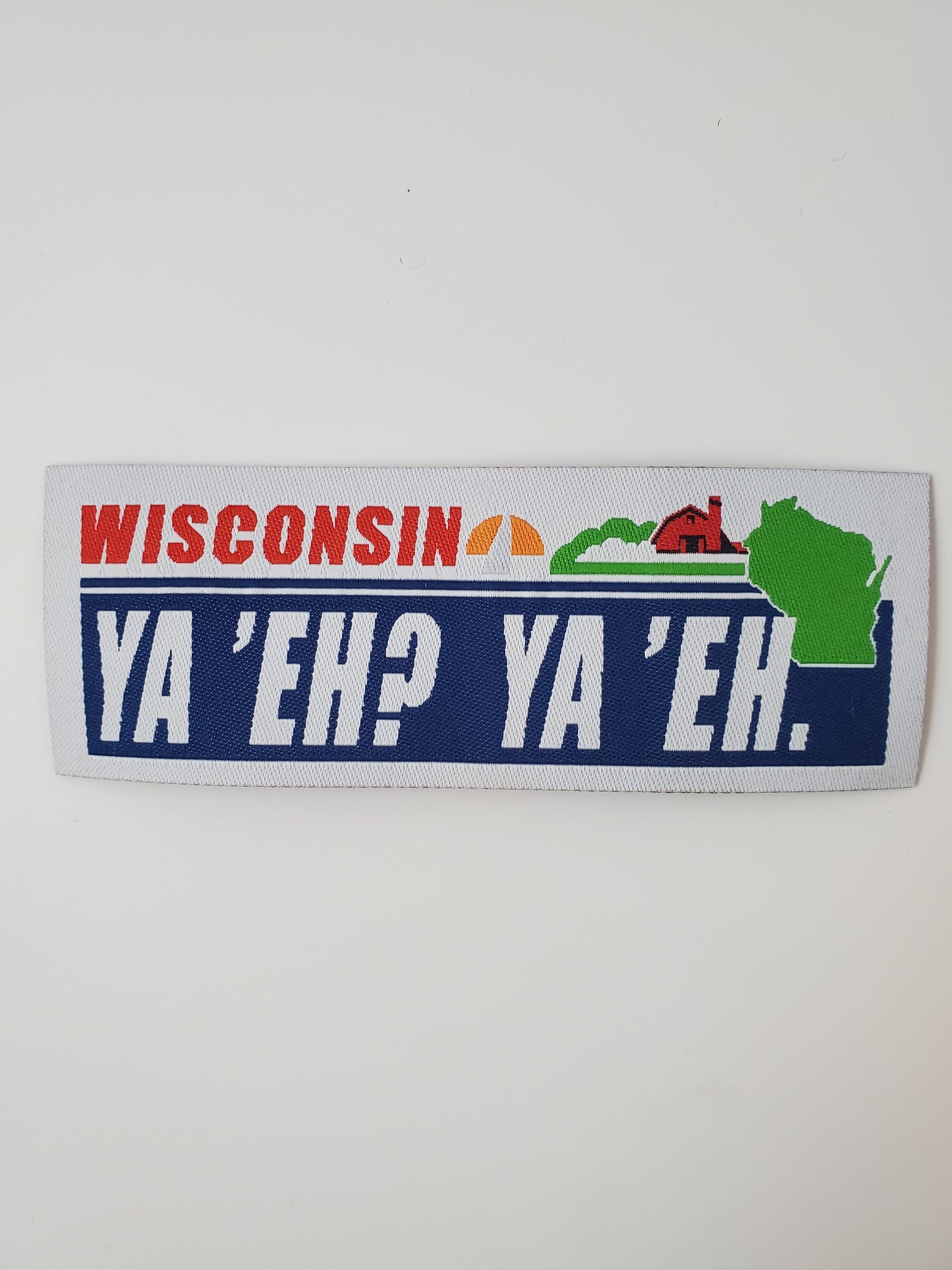 "Ya 'Eh? Ya 'Eh." Wisconsin Plate Design Trucker Hat (White Mesh/ Charcoal Fabric)