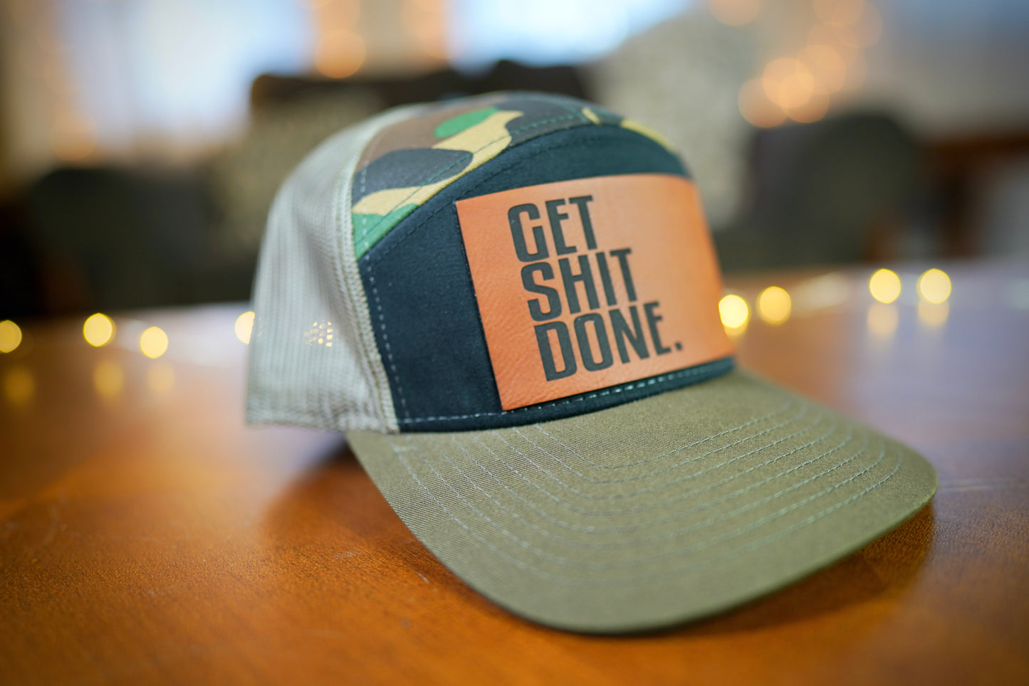 "GET SHIT DONE" 7 Panel Trucker Hat (Black/ Green Camo/ Loden)