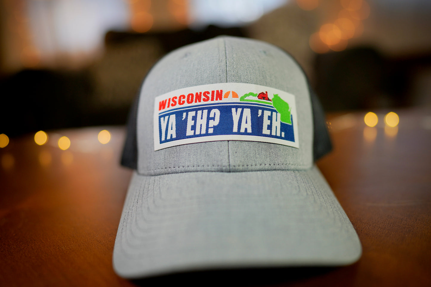 "Ya 'Eh? Ya 'Eh." Wisconsin Plate Design Trucker Hat (Black Mesh/ Heather Grey Fabric)
