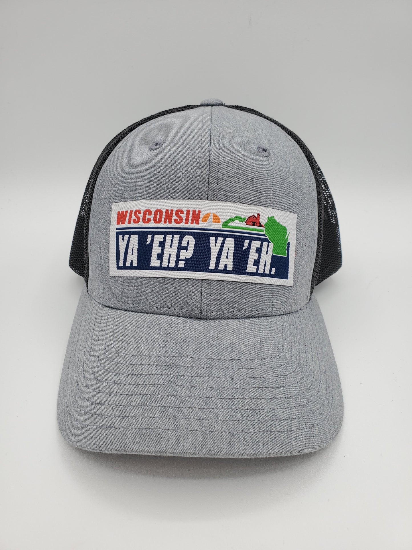"Ya 'Eh? Ya 'Eh." Wisconsin Plate Design Trucker Hat (Black Mesh/ Heather Grey Fabric)